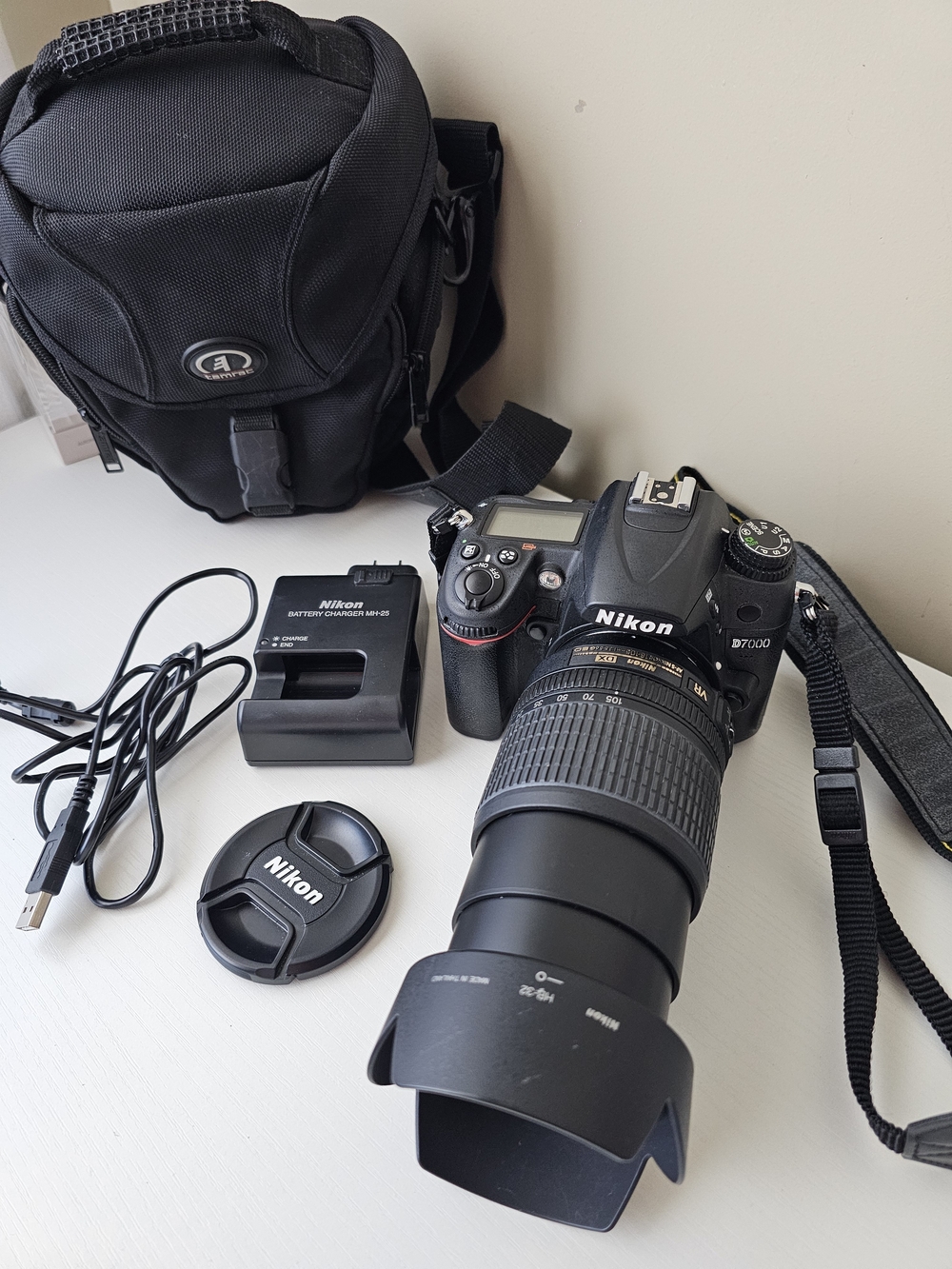 Nikon D7000 DSLR Camera with Black Telephoto Lens and Accessories
